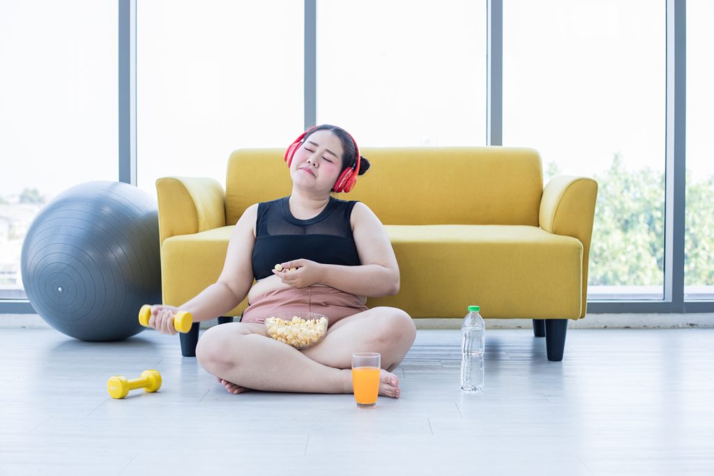 Asian eating while exercising image.