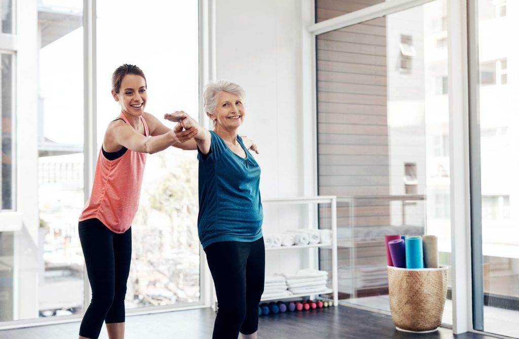 elderly lady working out with coach image